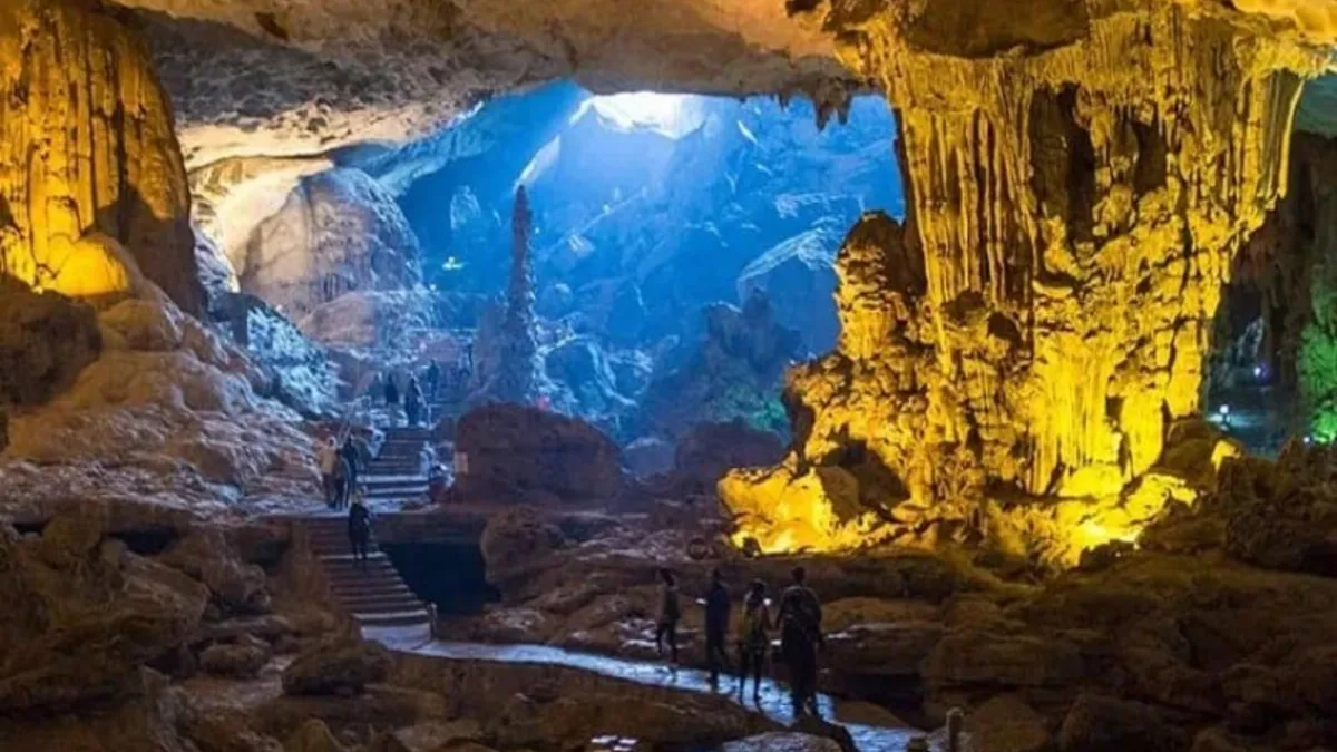Dau Go Cave's bright first chamber with towering stalactite columns resembling silent guardians, Halong Bay