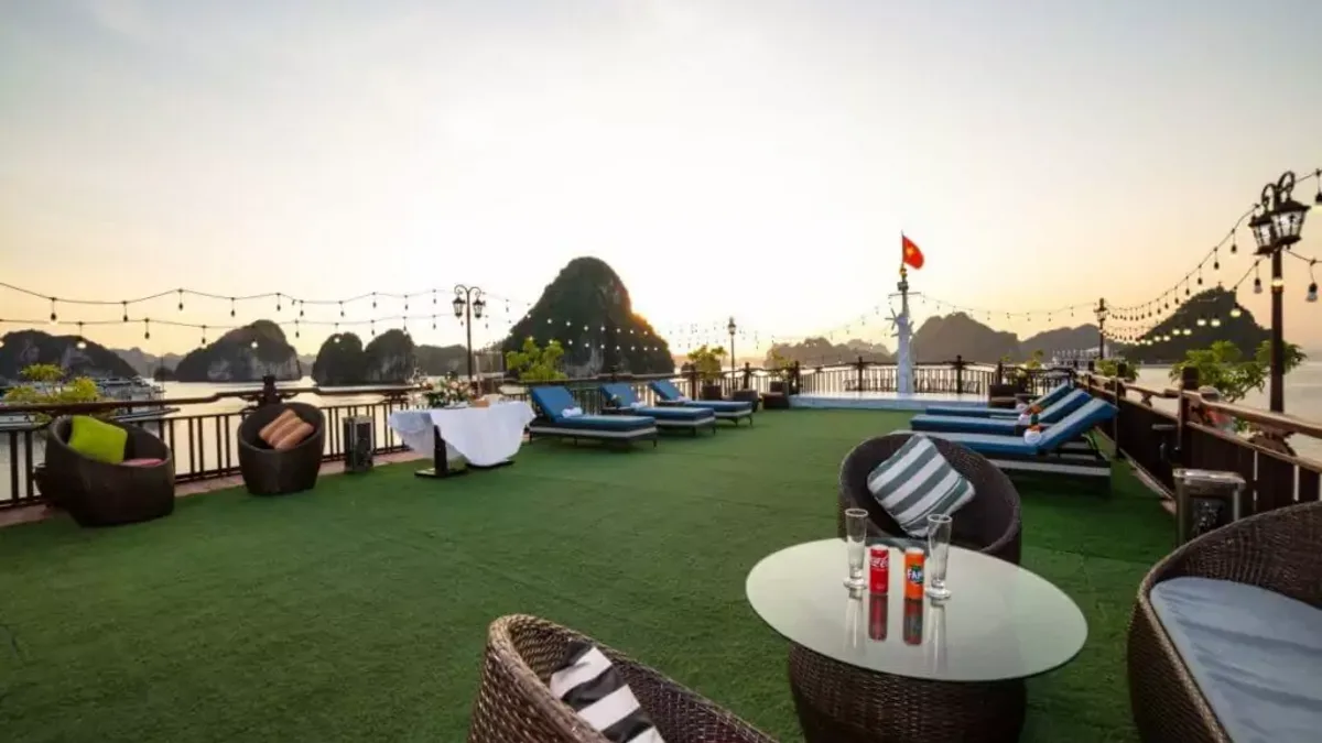 Sundeck lounge of Amanda Cruise at sunset in Halong Bay