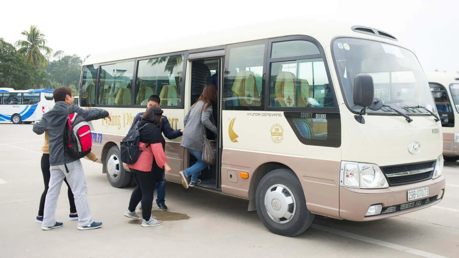 Halong Phoenix Day Cruise – Shuttle Bus Transfer Guests boarding the Halong Phoenix Day Cruise shuttle bus for transfer from Hanoi