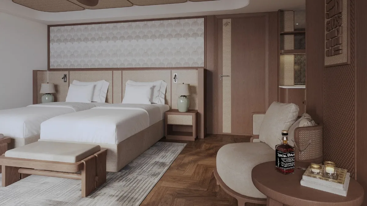 Ocean View Suite on Harmony Boutique Cruise with king bed and armchair