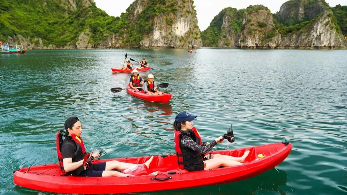 Kayaking through Cong Dam Area's tranquil limestone karst corridor, Bai Tu Long Bay's signature activity, Vietnam