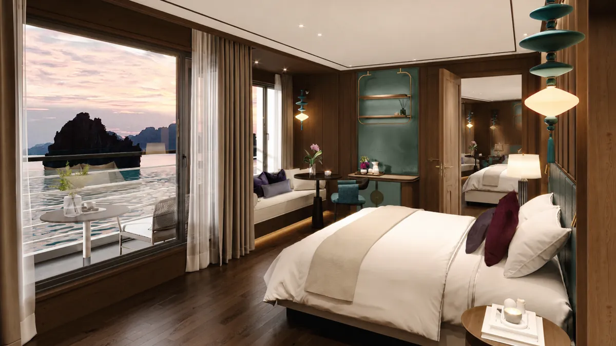 King bed facing the bay in a Premium Suite Balcony on Orchid Luxury Cruise