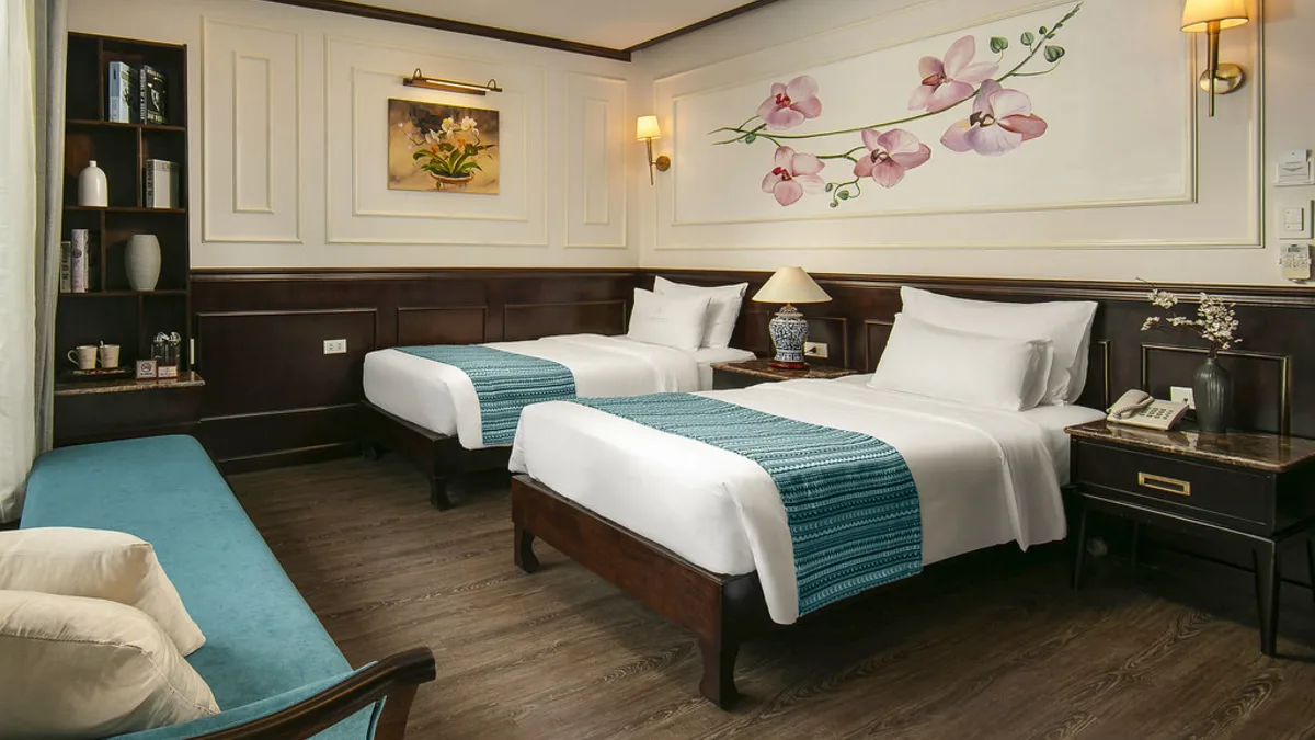 Twin beds in a Deluxe Balcony cabin on Orchid Trendy Cruise
