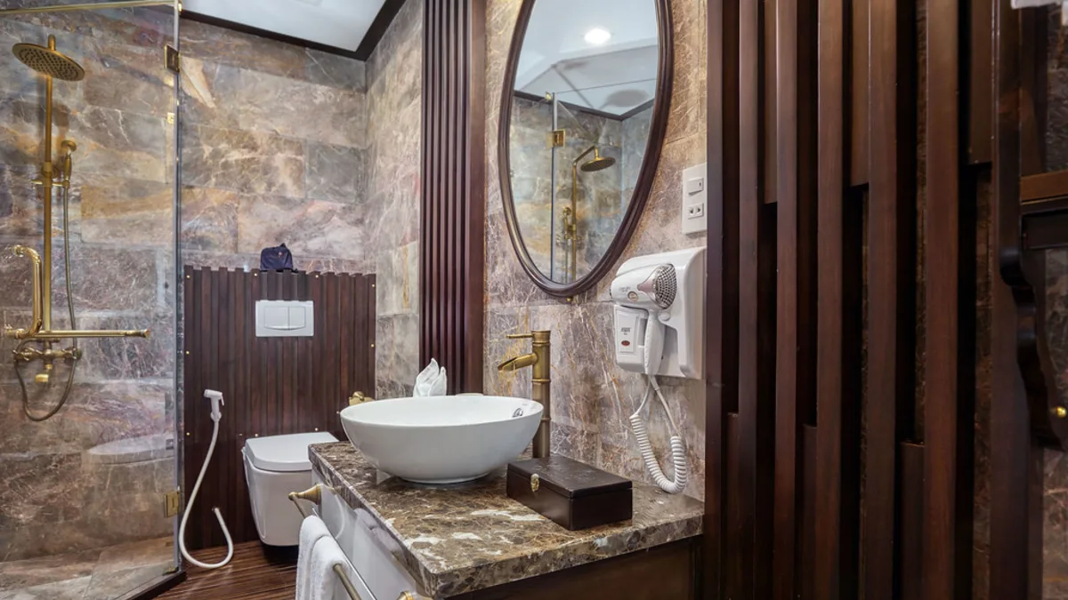 Bathroom with bathtub in a Deluxe cabin on Orchid Trendy Cruise