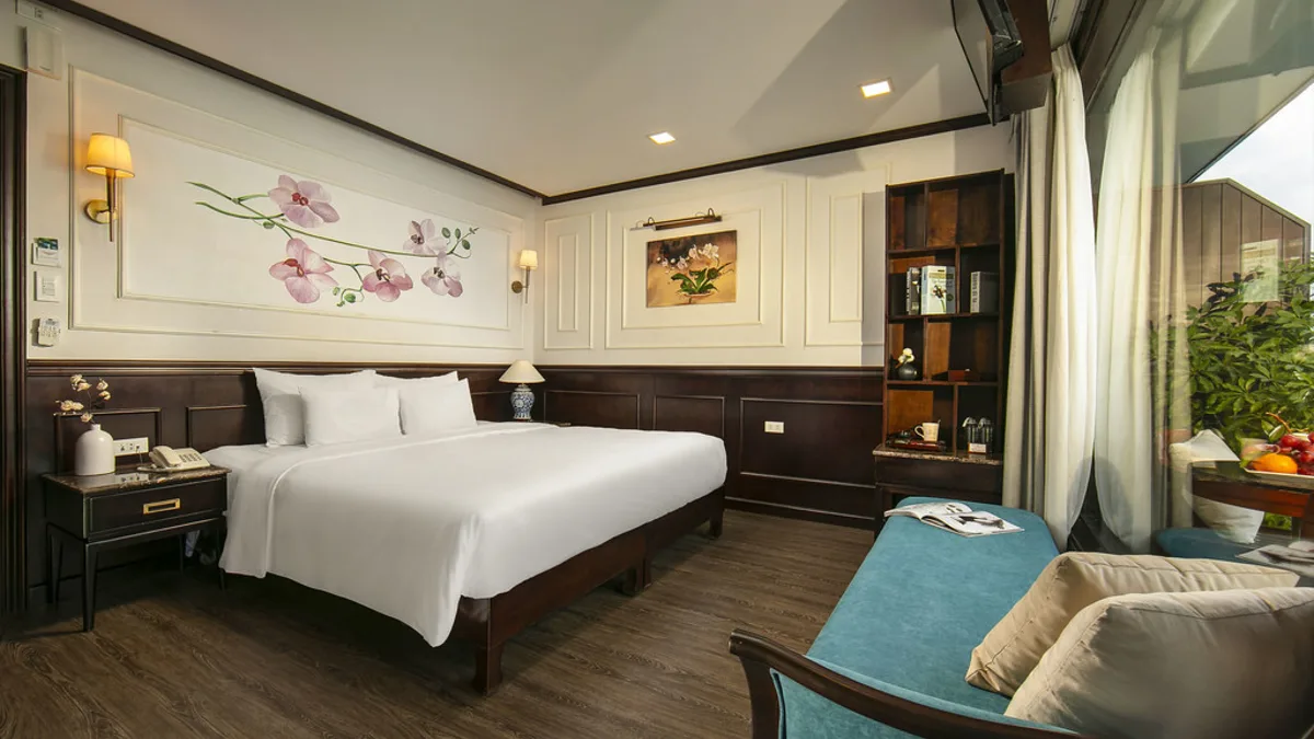 King bed in a Premium Deluxe Balcony cabin on Orchid Trendy Cruise