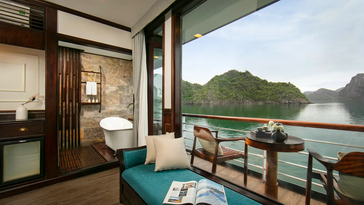 Sitting area and balcony door in a Premium Deluxe cabin on Orchid Trendy Cruise