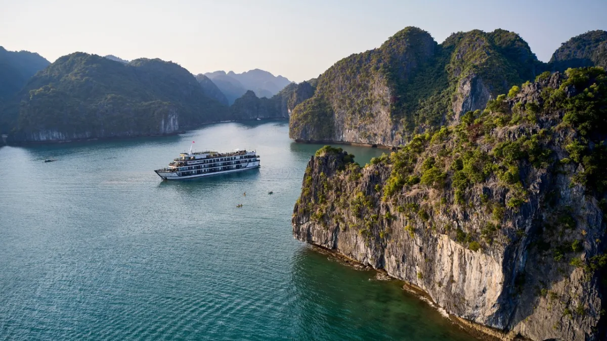 Junior Suite bedroom with private balcony and Halong Bay view