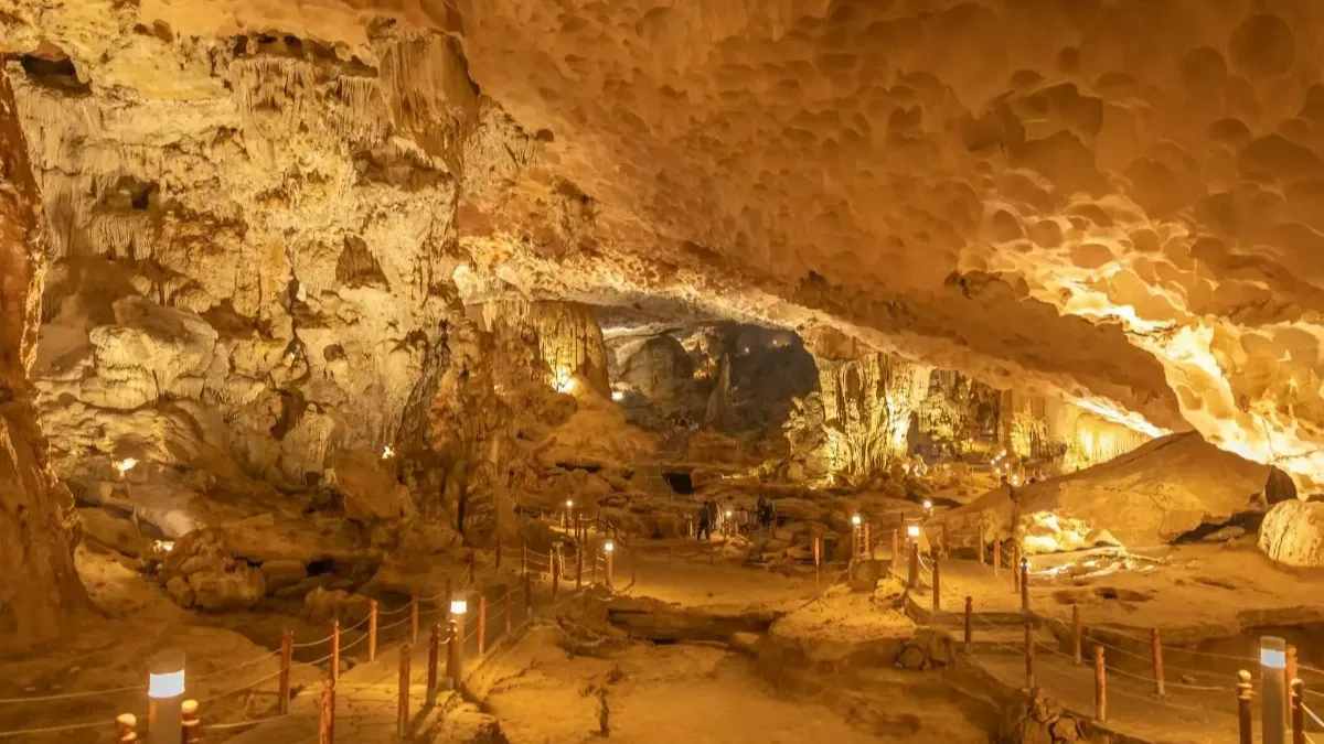 Sung Sot Cave second chamber "Grand Hall" — 30-meter high ceiling with massive stalactites and stalagmites shaped like Buddha and animals, Halong Bay Vietnam