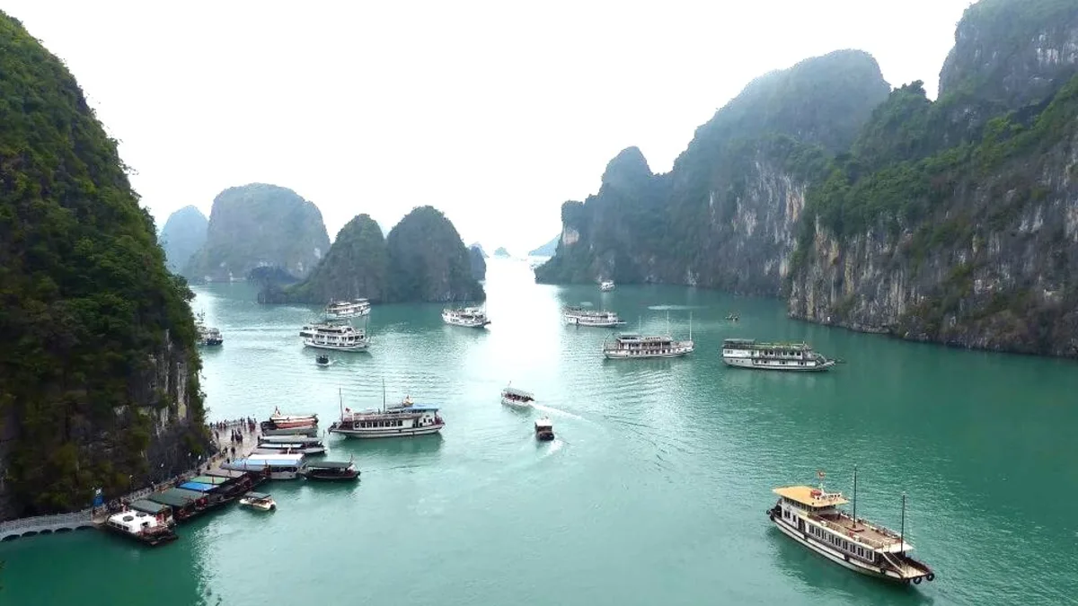 Panoramic viewpoint at Sung Sot Cave exit — sweeping view of Halong Bay limestone islands and emerald waters, Vietnam