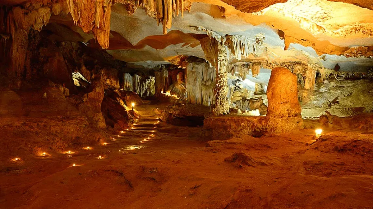 Thien Canh Son Cave interior — stalactite formations resembling lotus flowers and chandeliers, Bai Tu Long Bay's most spectacular cave, Vietnam