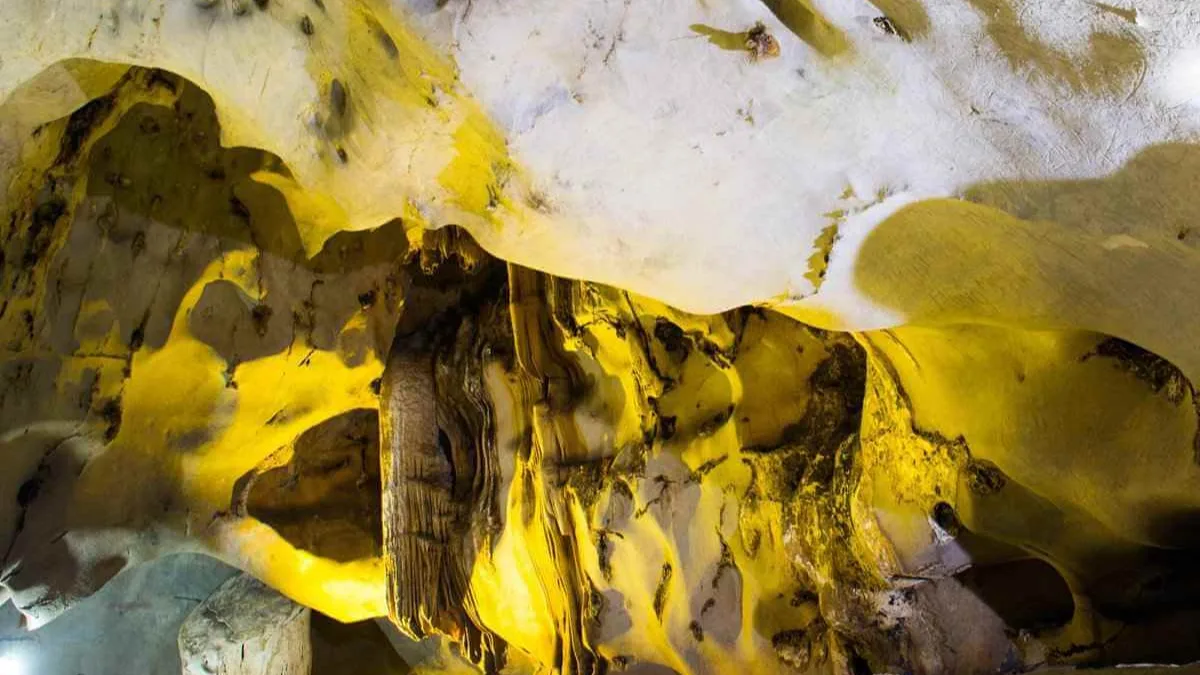 Unique stalactite and stalagmite shapes inside Trung Trang Cave, resembling natural sculptures, Cat Ba Island Vietnam